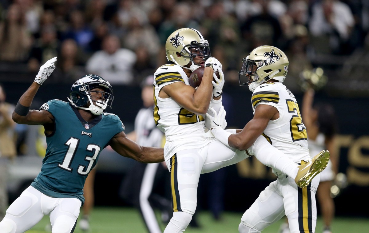 Nov 18, 2018; New Orleans, LA, USA; New Orleans Saints cornerback Marshon Lattimore (23) makes an interception while defending Philadelphia Eagles wide receiver Nelson Agholor (13) in the first quarter at the Mercedes-Benz Superdome. Mandatory Credit: Chuck Cook-USA TODAY 