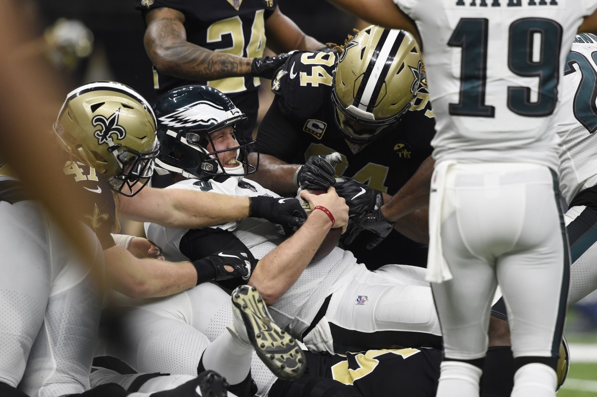 Jan 13, 2019; New Orleans, LA, USA; Philadelphia Eagles quarterback Nick Foles (9) reacts after scoring a touchdown against New Orleans Saints middle linebacker Alex Anzalone (47) and defensive end Cameron Jordan (94) during the first quarter of a NFC Divisional playoff football game at Mercedes-Benz Superdome. Mandatory Credit: John David Mercer-USA TODAY Sports