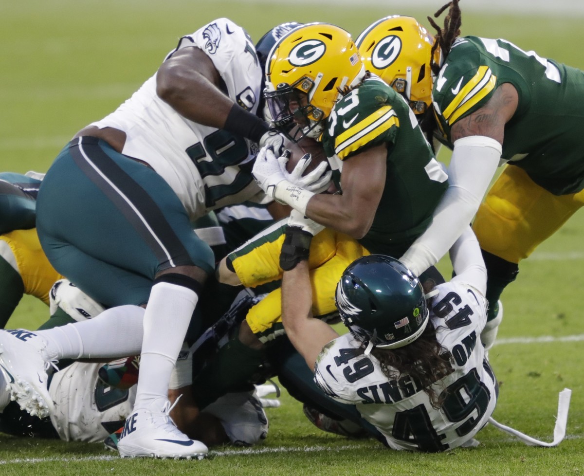 Dec 6, 2020; Green Bay, WI, USA; Green Bay Packers running back Aaron Jones (33) runs for a first down against Philadelphia Eagles defensive tackle Fletcher Cox (91) and linebacker Alex Singleton (49) during their football game Sunday, December 6, 2020, at Lambeau Field in Green Bay, Wis. Mandatory Credit: Dan Powers-USA TODAY NETWORK