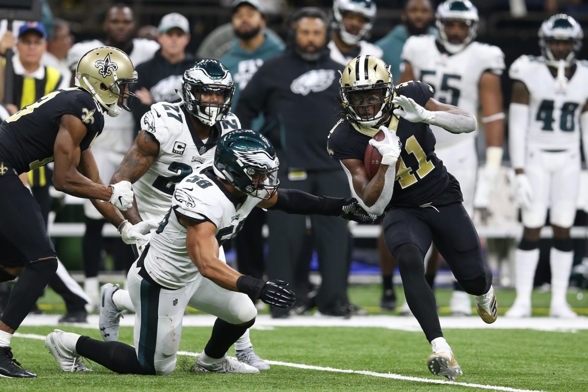 Jan 13, 2019; New Orleans, LA, USA; New Orleans Saints running back Alvin Kamara (41) runs against Philadelphia Eagles middle linebacker Jordan Hicks (58) and strong safety Malcolm Jenkins (27) during the third quarter of a NFC Divisional playoff football game at Mercedes-Benz Superdome. Mandatory Credit: Chuck Cook-USA TODAY 