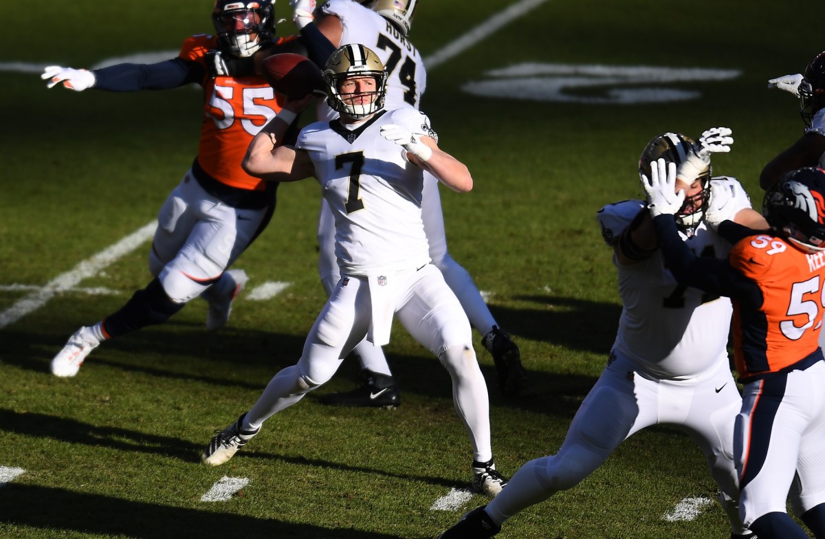 iNov 29, 2020; Denver, Colorado, USA; New Orleans Saints quarterback Taysom Hill (7) passes in the first quarter against the Denver Broncos at Empower Field at Mile High. Mandatory Credit: Ron Chenoy-USA TODAY