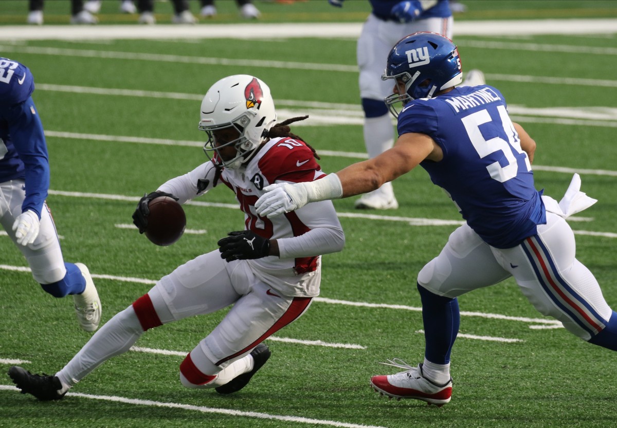 DeAndre Hopkins of the Cardinals runs after the catch and is tackled by Blake Martinez of the Giants in the first half as the Arizona Cardinals played the New York Giants at MetLife Stadium in East Rutherford, NJ on December 13, 2020.