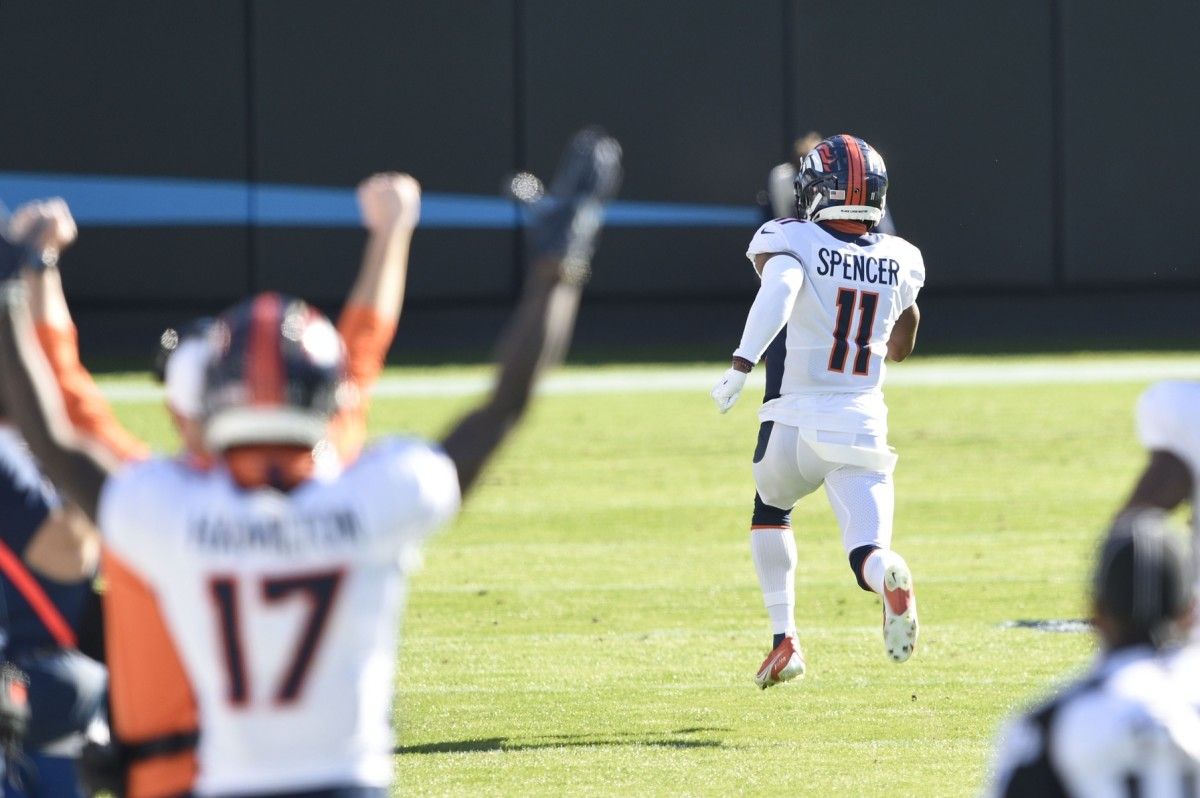 Denver Broncos punt returner Spencer (11) returns a punt for a touchdown in the first quarter at Bank of America Stadium.