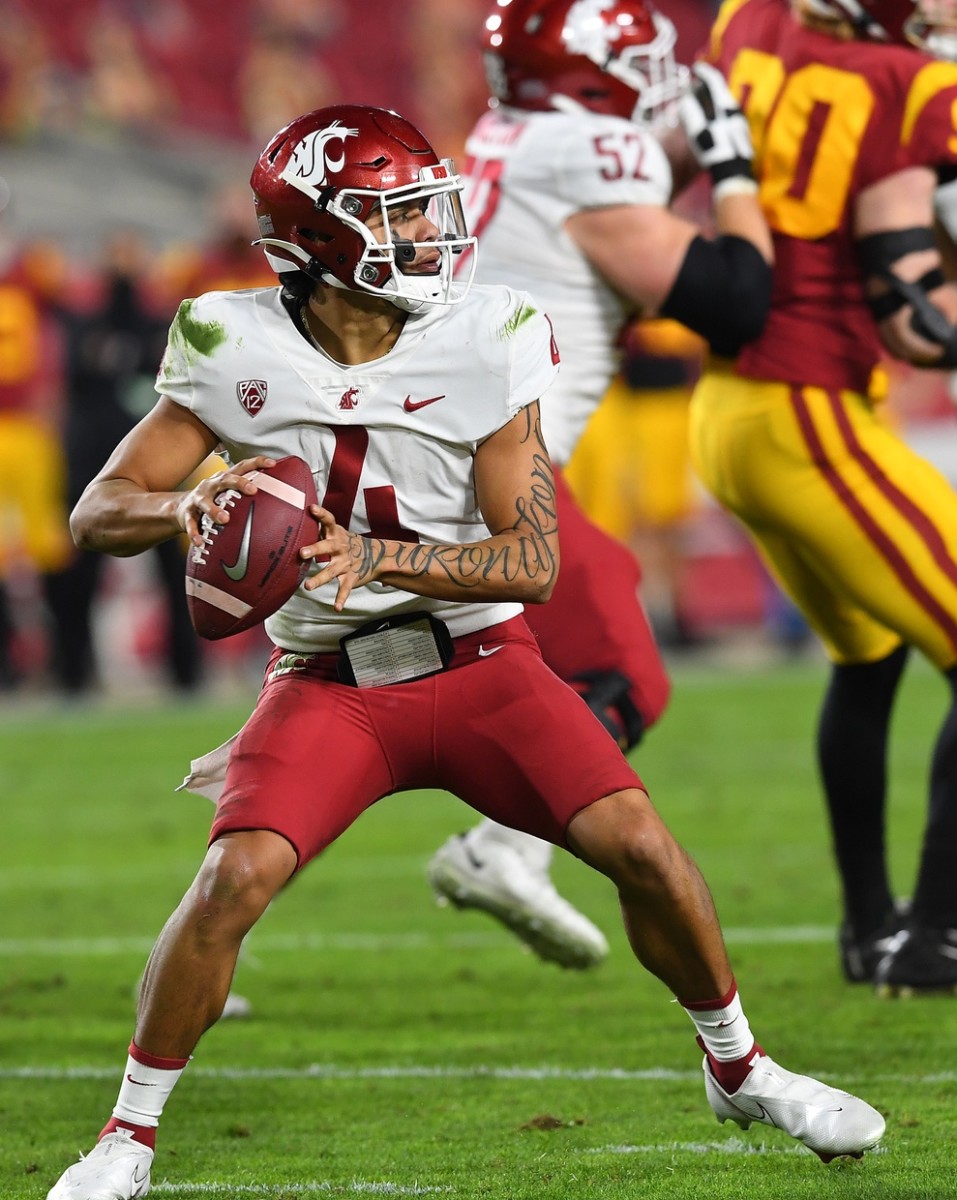Dec 6, 2020; Los Angeles, California, USA; Washington State Cougars quarterback Jayden de Laura (4) sets to pass the ball in the first half against the USC Trojans at United Airlines Field at the Los Angeles Memorial Coliseum.