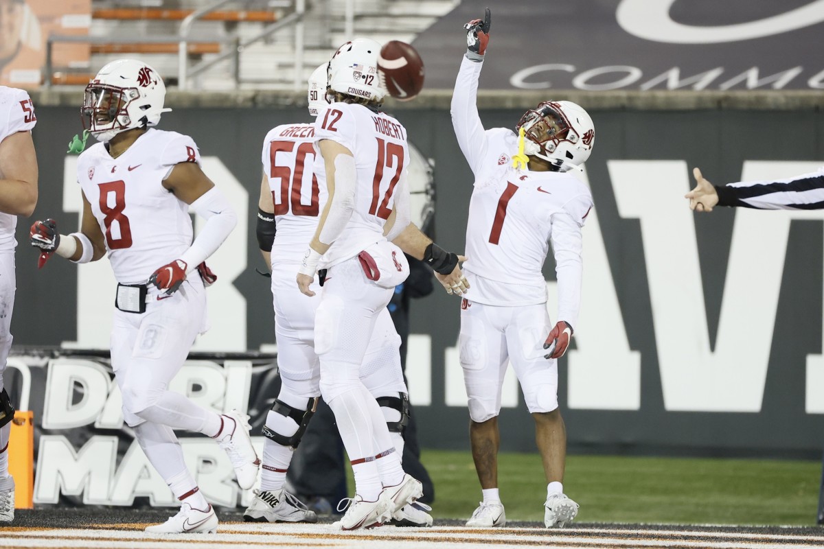 Nov 7, 2020; Corvallis, Oregon, USA; Washington State Cougars wide receiver Travell Harris (1) celebrates after catching a pass for a touchdown with teammates during the second half against the Oregon State Beavers at Reser Stadium.
