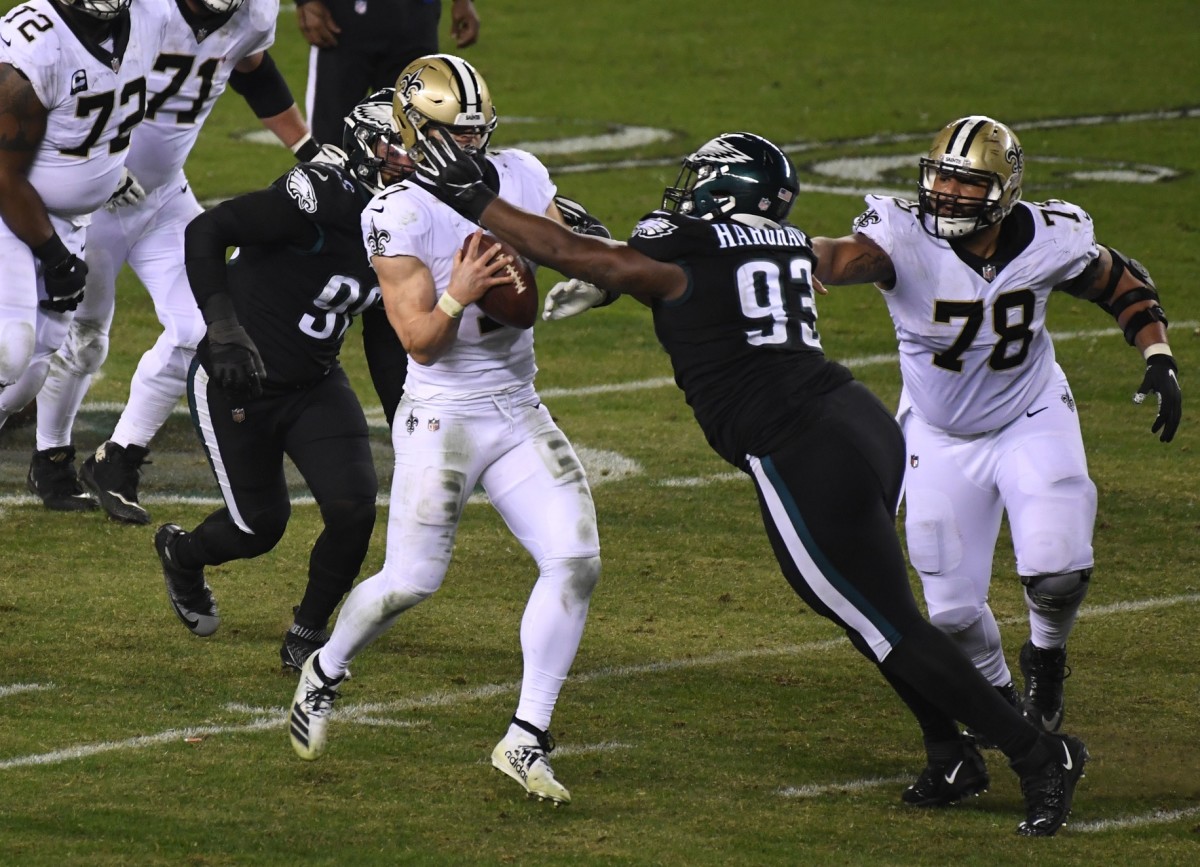 Dec 13, 2020; Philadelphia, Pennsylvania, USA; New Orleans Saints quarterback Taysom Hill (7) is pressured by Philadelphia Eagles nose tackle Javon Hargrave (93) as center Erik McCoy (78) looks on in the fourth quarter at Lincoln Financial Field. Mandatory Credit: James Lang-USA TODAY 