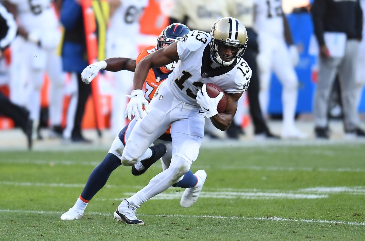 Nov 29, 2020; Denver, Colorado, USA; New Orleans Saints wide receiver Michael Thomas (13) carries the ball against the Denver Broncos in the second quarter at Empower Field at Mile High. Mandatory Credit: Ron Chenoy-USA TODAY 