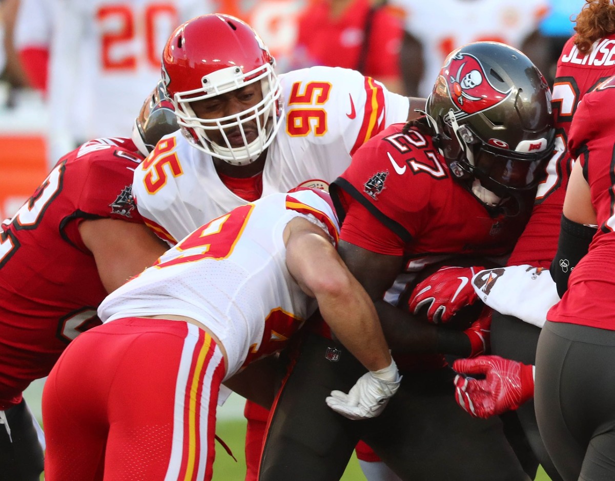 Nov 29, 2020; Tampa, Florida, USA; Tampa Bay Buccaneers running back Ronald Jones (27) runs the ball as Kansas City Chiefs defensive tackle Chris Jones (95) moves in for the tackle during the first half at Raymond James Stadium. Mandatory Credit: Kim Klement-USA TODAY 