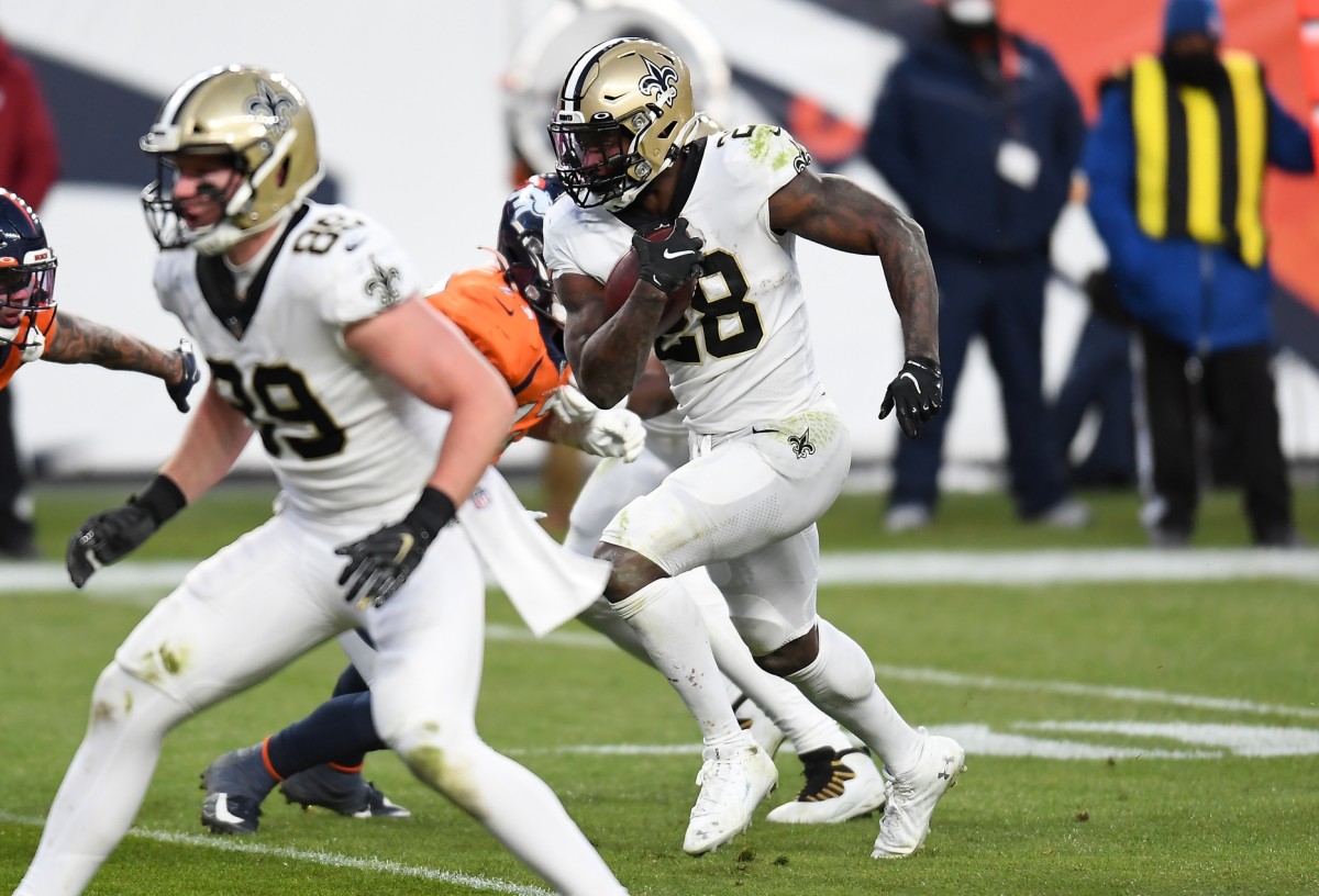 Nov 29, 2020; Denver, Colorado, USA; New Orleans Saints running back Latavius Murray (28) carries for a touchdown in the fourth quarter against the Denver Broncos at Empower Field at Mile High. Mandatory Credit: Ron Chenoy-USA TODAY 