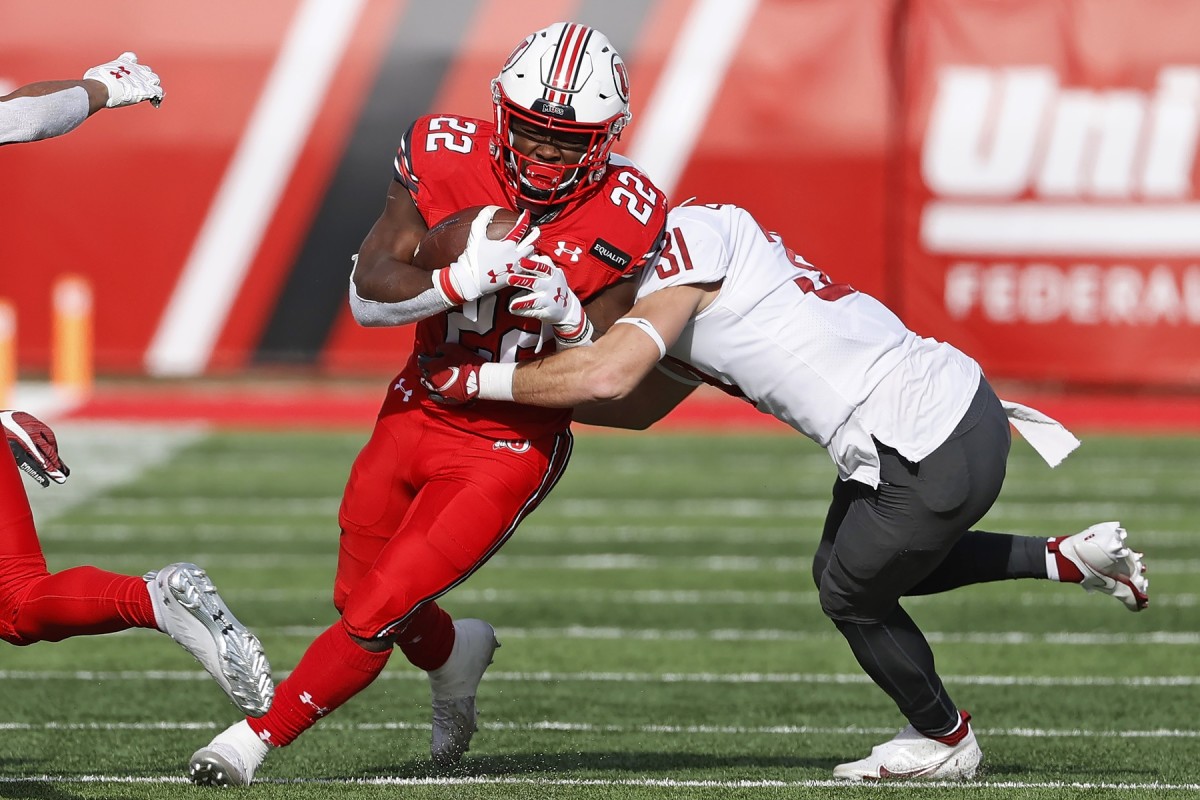 Dec 19, 2020; Salt Lake City, Utah, USA; Utah Utes running back Ty Jordan (22) runs the ball against Washington State Cougars defensive back Hunter Escorcia (31) in the second quarter at Rice-Eccles Stadium.