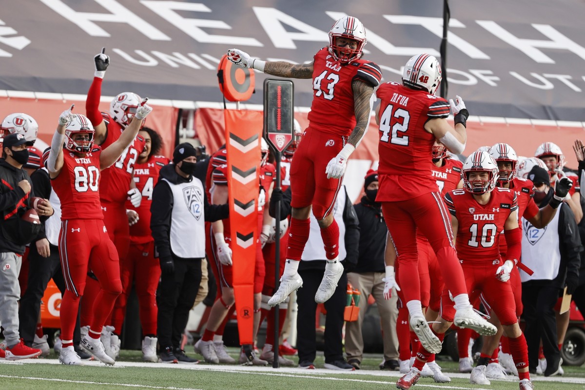 Dec 19, 2020; Salt Lake City, Utah, USA; Utah Utes tight end Mufi Hill-Hunt (43) and defensive end Mika Tafua (42) celebrate after a turnover in the fourth quarter against the Washington State Cougars at Rice-Eccles Stadium.