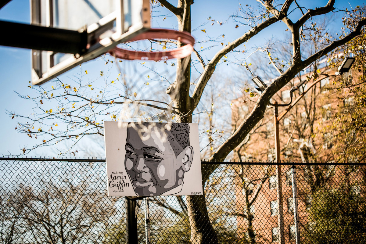 A mural of Aamir Griffin's face spans a backboard at the Baisley Park Houses basketball court.