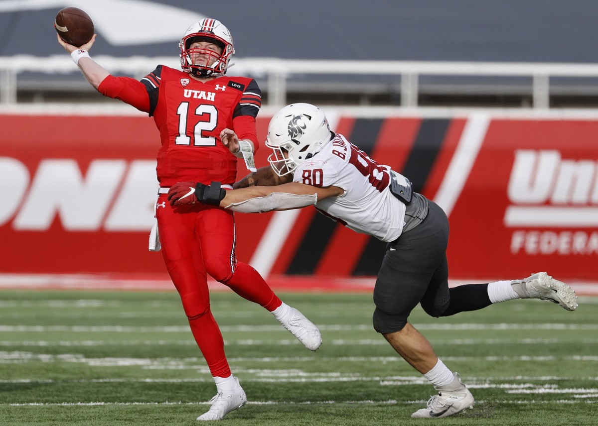 Dec 19, 2020; Salt Lake City, Utah, USA; Utah Utes quarterback Drew Lisk (12) passes under pressure by Washington State Cougars defensive end Brennan Jackson (80) in the fourth quarter at Rice-Eccles Stadium.