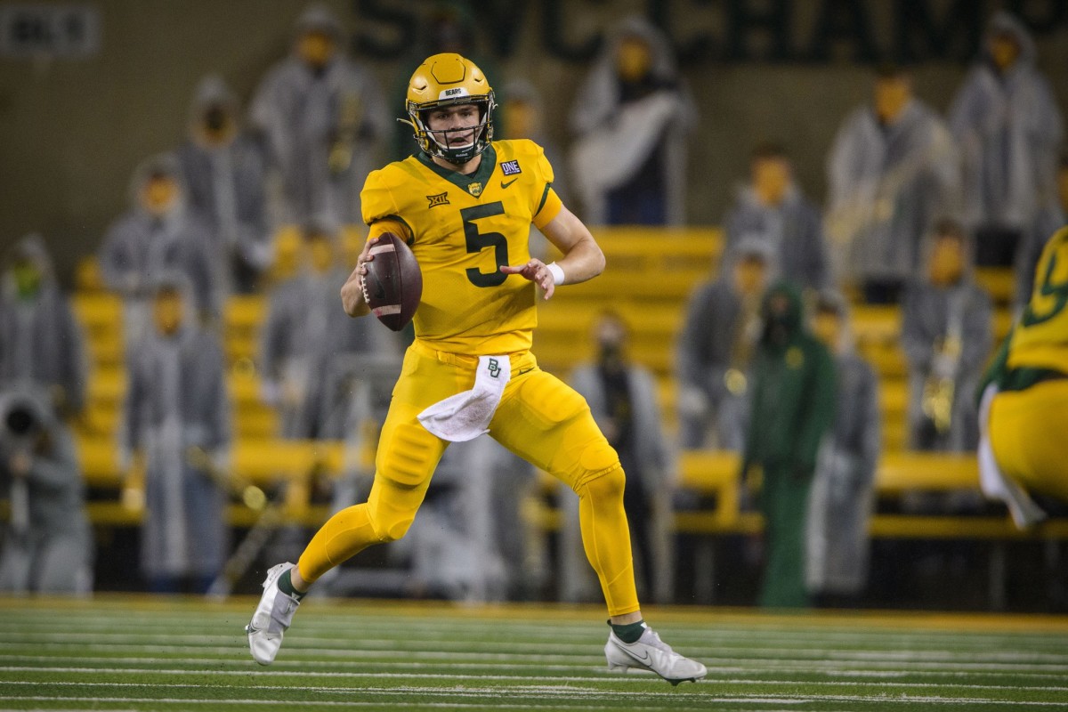 Nov 28, 2020; Waco, Texas, USA; Baylor Bears quarterback Charlie Brewer (5) rolls out against the Kansas State Wildcats during the first quarter at McLane Stadium.