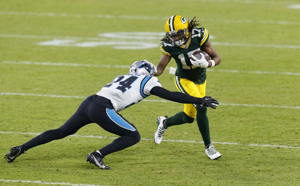 Green Bay Packers wide receiver Davante Adams (17) is tackled by Carolina Panthers cornerback Rasul Douglas (24) after catching a pass during the second quarter at Lambeau Field.