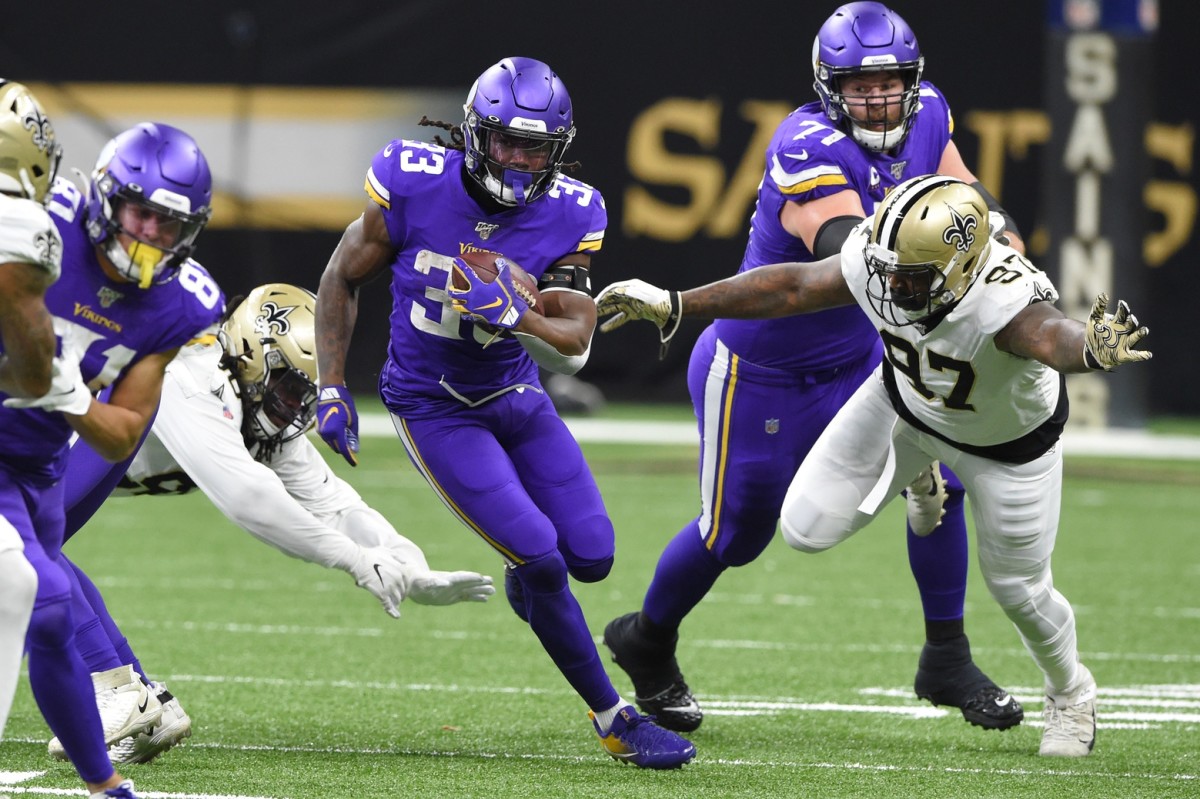 Jan 5, 2020; New Orleans, Louisiana, USA; Minnesota Vikings running back Dalvin Cook (33) runs the ball against New Orleans Saints defensive end Mario Edwards (97) during the first quarter of a NFC Wild Card playoff football game at the Mercedes-Benz Superdome. Mandatory Credit: John David Mercer-USA TODAY 