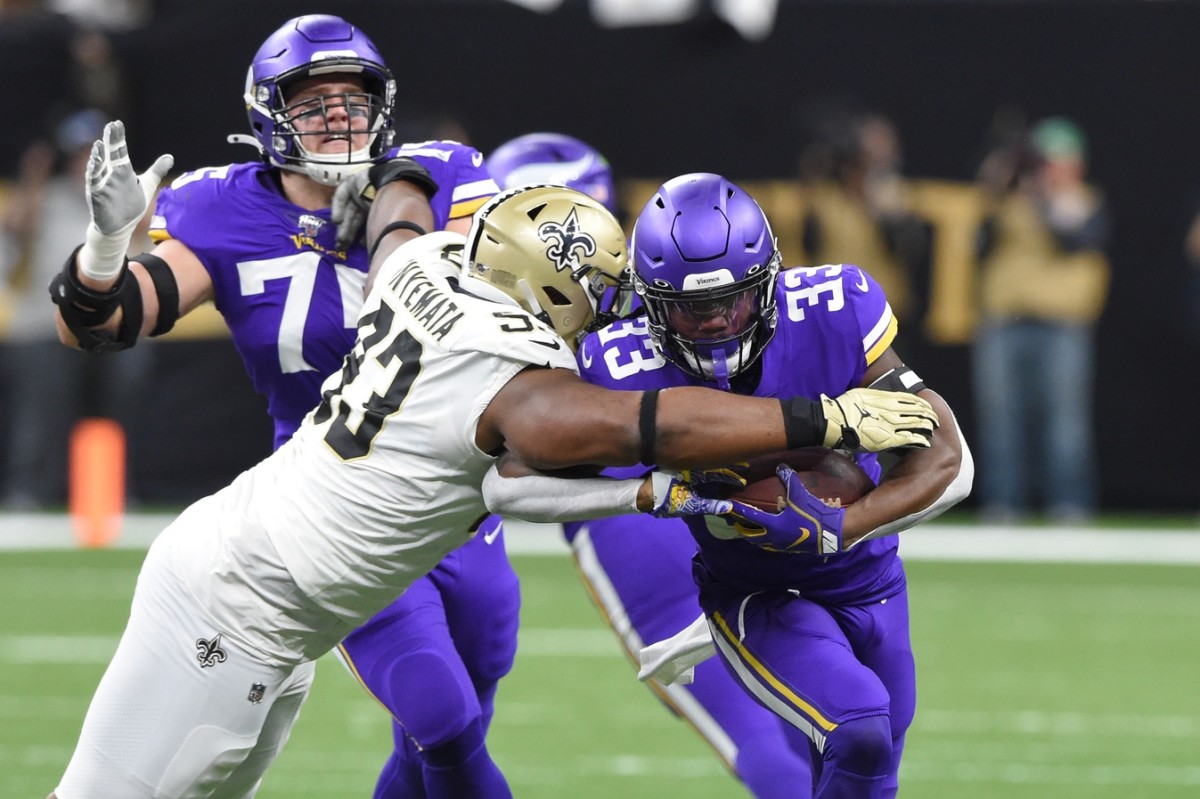 Jan 5, 2020; New Orleans, Louisiana, USA; Minnesota Vikings running back Dalvin Cook (33) runs the ball against New Orleans Saints defensive tackle David Onyemata (93) during the first quarter of a NFC Wild Card playoff football game at the Mercedes-Benz Superdome. Mandatory Credit: John David Mercer-USA TODAY 