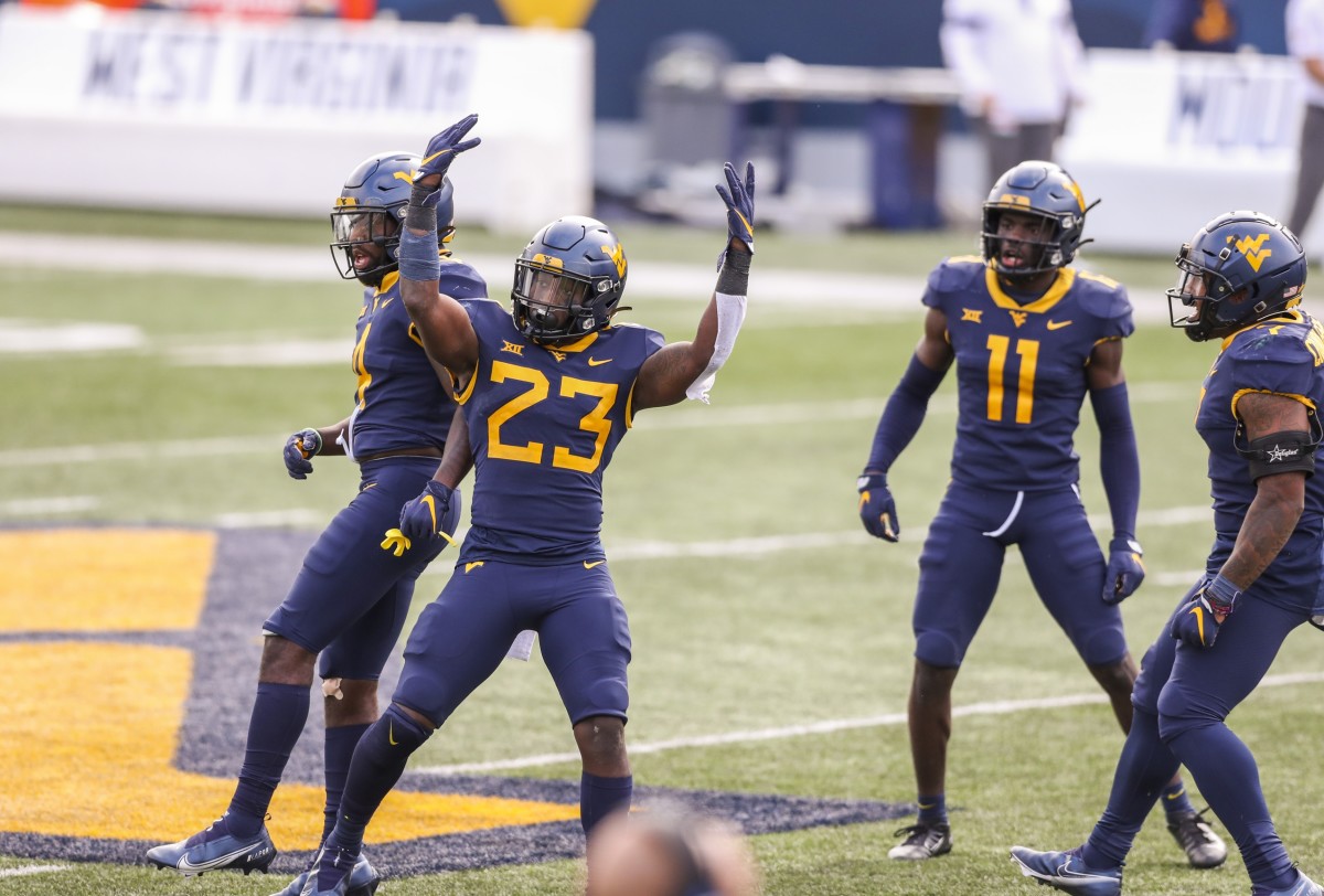 Oct 3, 2020; Morgantown, West Virginia, USA; West Virginia Mountaineers linebacker Tykee Smith (23) celebrates with teammates after intercepting a pass from Baylor Bears quarterback Charlie Brewer (5) during the second overtime at Mountaineer Field at Milan Puskar Stadium.