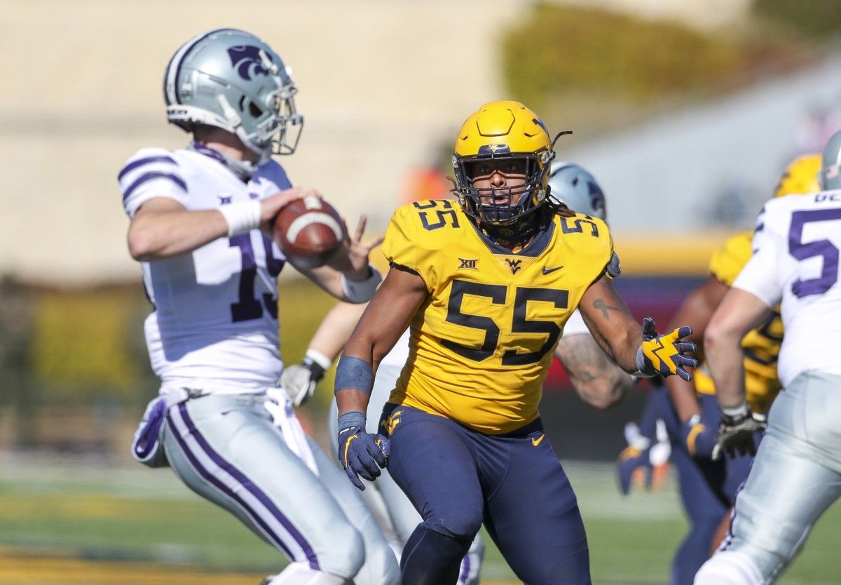 West Virginia Mountaineers defensive lineman Dante Stills (55) rushes Kansas State Wildcats quarterback Will Howard (15) during the second quarter at Mountaineer Field at Milan Puskar Stadium.