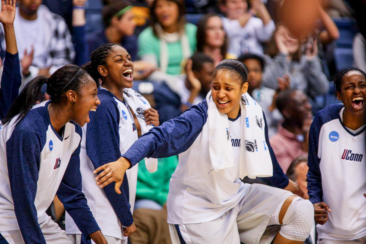 Tina Charles and Maya Moore laugh with UConn teammates