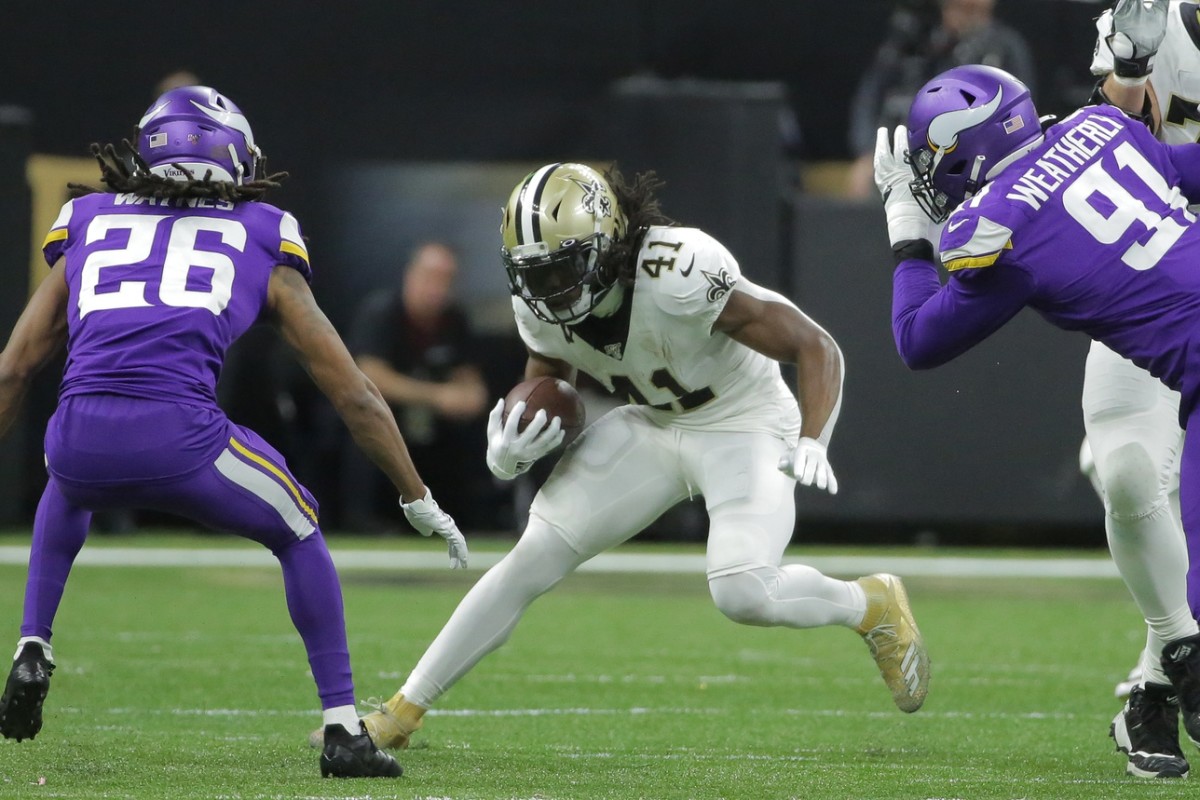 Jan 5, 2020; New Orleans, Louisiana, USA; New Orleans Saints running back Alvin Kamara (41) runs the ball against Minnesota Vikings cornerback Trae Waynes (26) and defensive end Stephen Weatherly (91) during the second quarter of a NFC Wild Card playoff football game at the Mercedes-Benz Superdome. Mandatory Credit: Derick Hingle-USA TODAY 