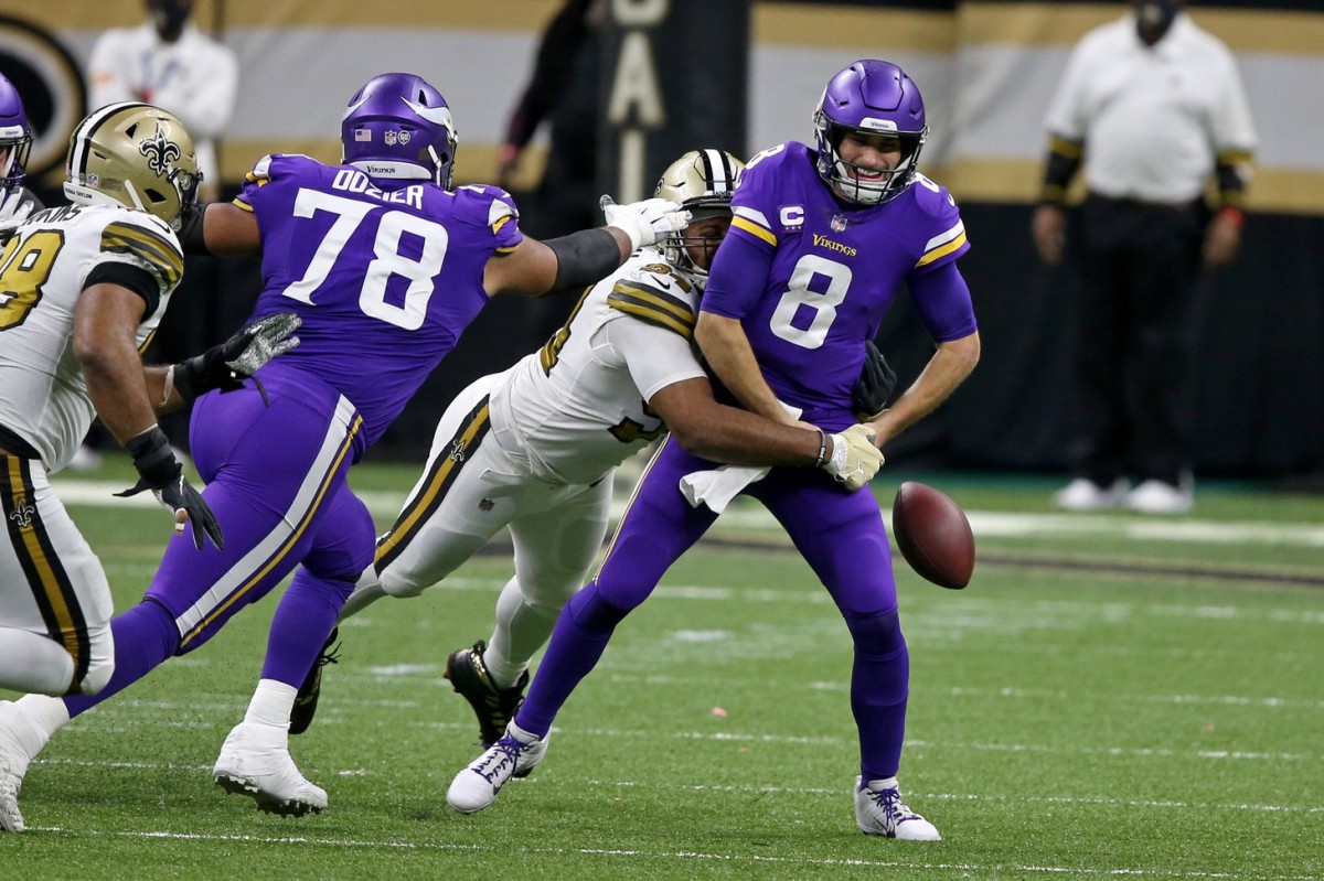 Dec 25, 2020; New Orleans, Louisiana, USA; Minnesota Vikings quarterback Kirk Cousins (8) fumbles after a sack by New Orleans Saints defensive end Cameron Jordan (94) in the second half at the Mercedes-Benz Superdome. Mandatory Credit: Chuck Cook-USA TODAY 