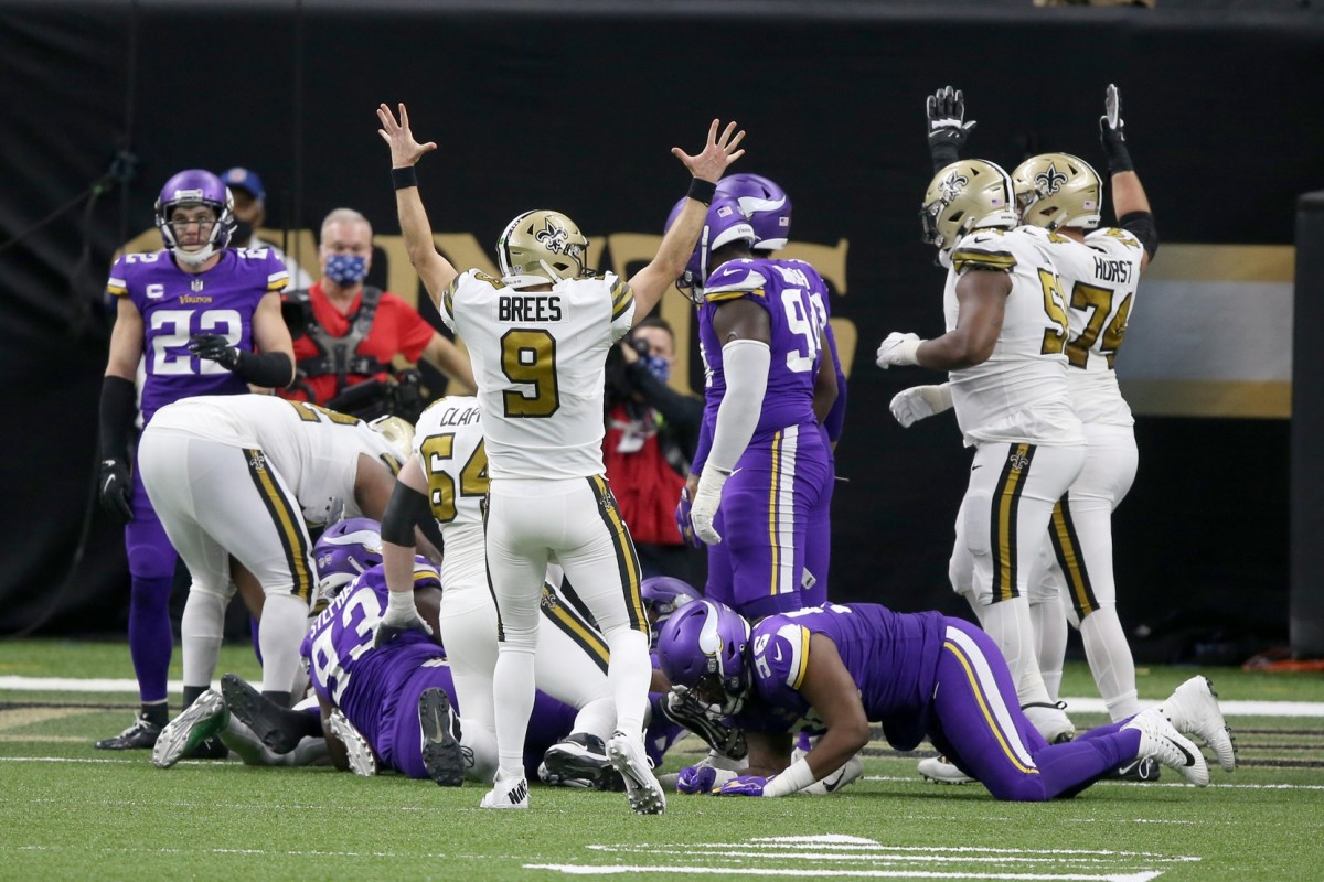 Dec 25, 2020; New Orleans, Louisiana, USA; New Orleans Saints quarterback Drew Brees (9) signals a touchdown in the fourth quarter after running back Alvin Kamara (41) scored his sixth touchdown against the Minnesota Vikings at the Mercedes-Benz Superdome. Mandatory Credit: Chuck Cook-USA TODAY 
