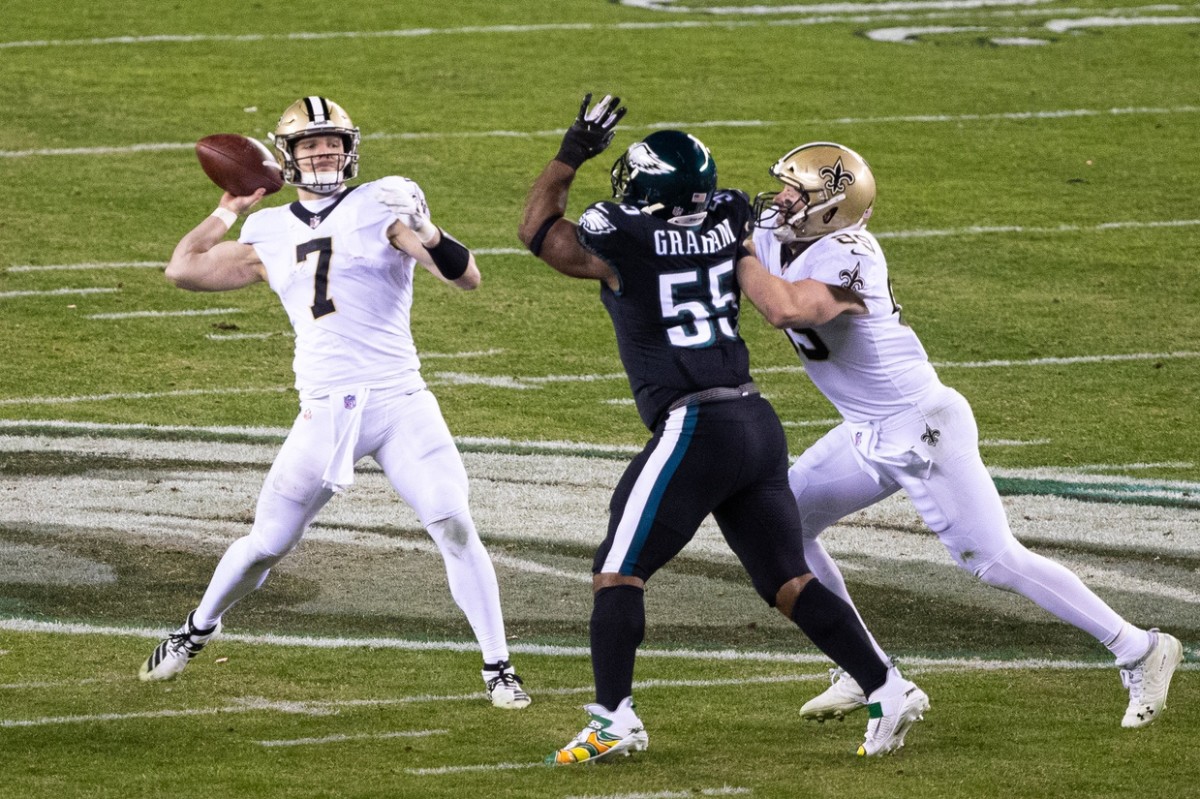 Dec 13, 2020; Philadelphia, Pennsylvania, USA; New Orleans Saints quarterback Taysom Hill (7) throws a touchdown pass in front of Philadelphia Eagles defensive end Brandon Graham (55) during the third quarter at Lincoln Financial Field. Mandatory Credit: Bill Streicher-USA TODAY