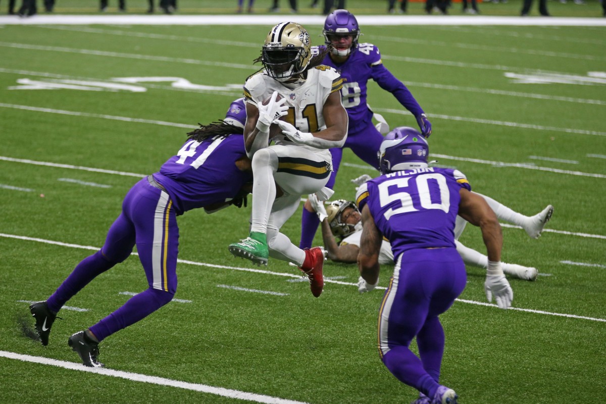 Dec 25, 2020; New Orleans, Louisiana, USA; New Orleans Saints running back Alvin Kamara (41) jumps into the end zone between defenders Minnesota Vikings Anthony Harris (41) and Eric Wilson (50) in the second half at the Mercedes-Benz Superdome. Mandatory Credit: Chuck Cook-USA TODAY 