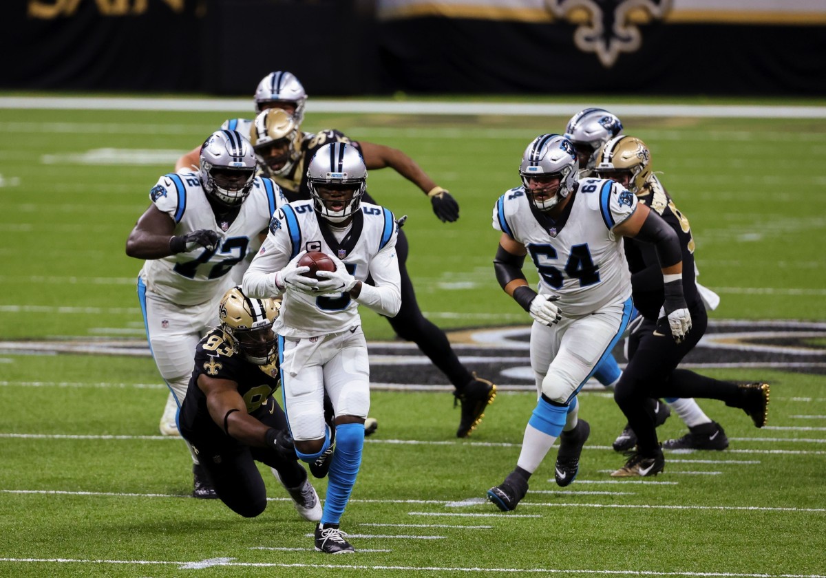 Oct 25, 2020; New Orleans, Louisiana, USA; Carolina Panthers quarterback Teddy Bridgewater (5) runs past New Orleans Saints defensive tackle David Onyemata (93) during the first quarter at the Mercedes-Benz Superdome. Mandatory Credit: Derick E. Hingle-USA TODAY