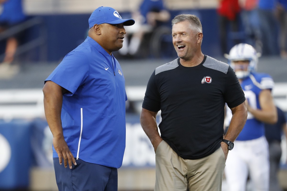 Aug 29, 2019; Provo, UT, USA; Brigham Young Cougars head coach Kalani Sitake, left and Utah Utes head coach Kyle Whittingham get together prior to their game at LaVell Edwards Stadium.