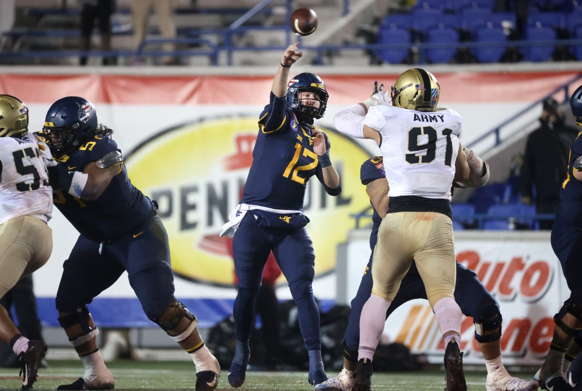 West Virginia Mountaineers quarterback Austin Kendall throws the ball against the Army Black Knights during the AutoZone Liberty Bowl in Memphis, Tenn.