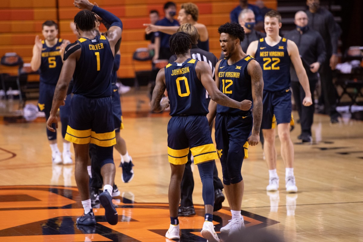 West Virginia Mountaineers guard Kedrian Johnson (0) and guard Taz Sherman (12) celebrate after defeating the Oklahoma State Cowboys 87-84 at Gallagher-Iba Arena.