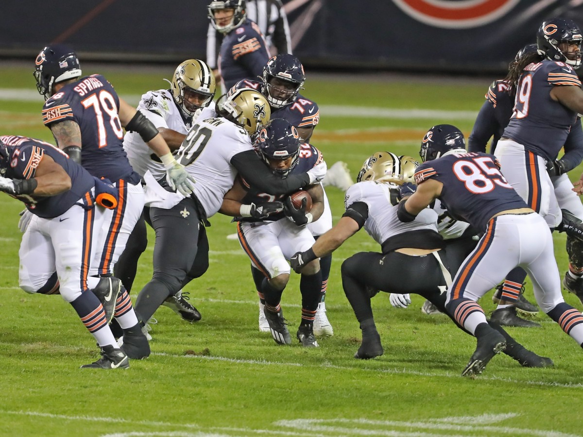 Nov 1, 2020; Chicago, Illinois, USA; Chicago Bears running back David Montgomery (32) runs with the ball with New Orleans Saints defensive tackle Malcom Brown (90) defending during the second half at Soldier Field. Mandatory Credit: Dennis Wierzbicki-USA TODAY 