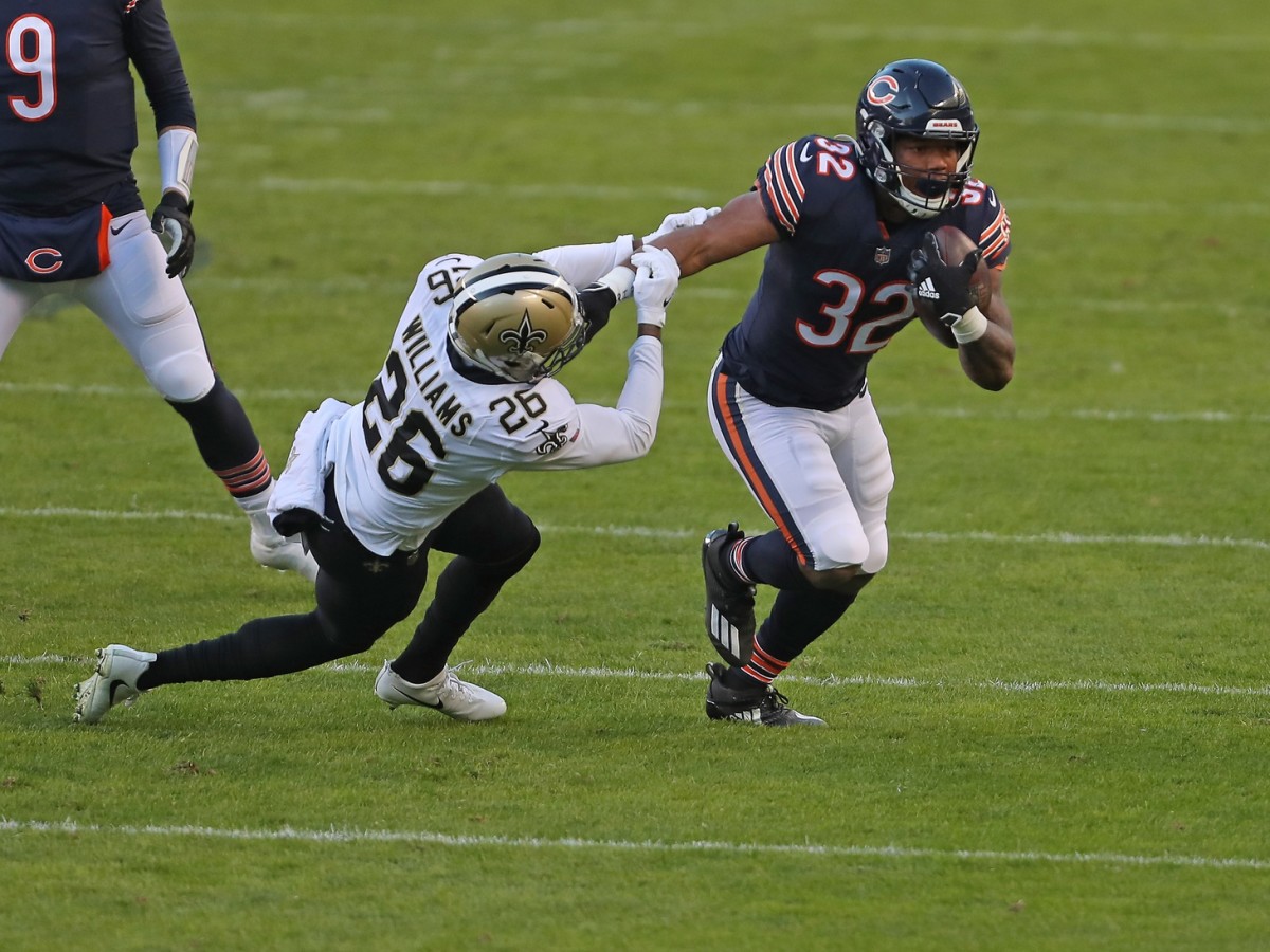 Nov 1, 2020; Chicago, Illinois, USA;Chicago Bears running back David Montgomery (32) runs out of the grasp of New Orleans Saints cornerback P.J. Williams (26) during the first quarter at Soldier Field. Mandatory Credit: Dennis Wierzbicki-USA TODAY Sports