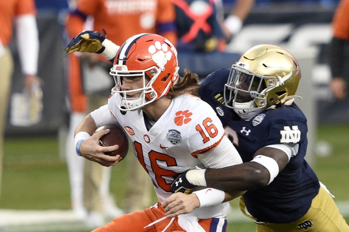 Clemson Tigers quarterback Trevor Lawrence (16) with the ball as Notre Dame Fighting Irish linebacker Jeremiah Owusu-Koramoah (6) defends in the second quarter at Bank of America Stadium.