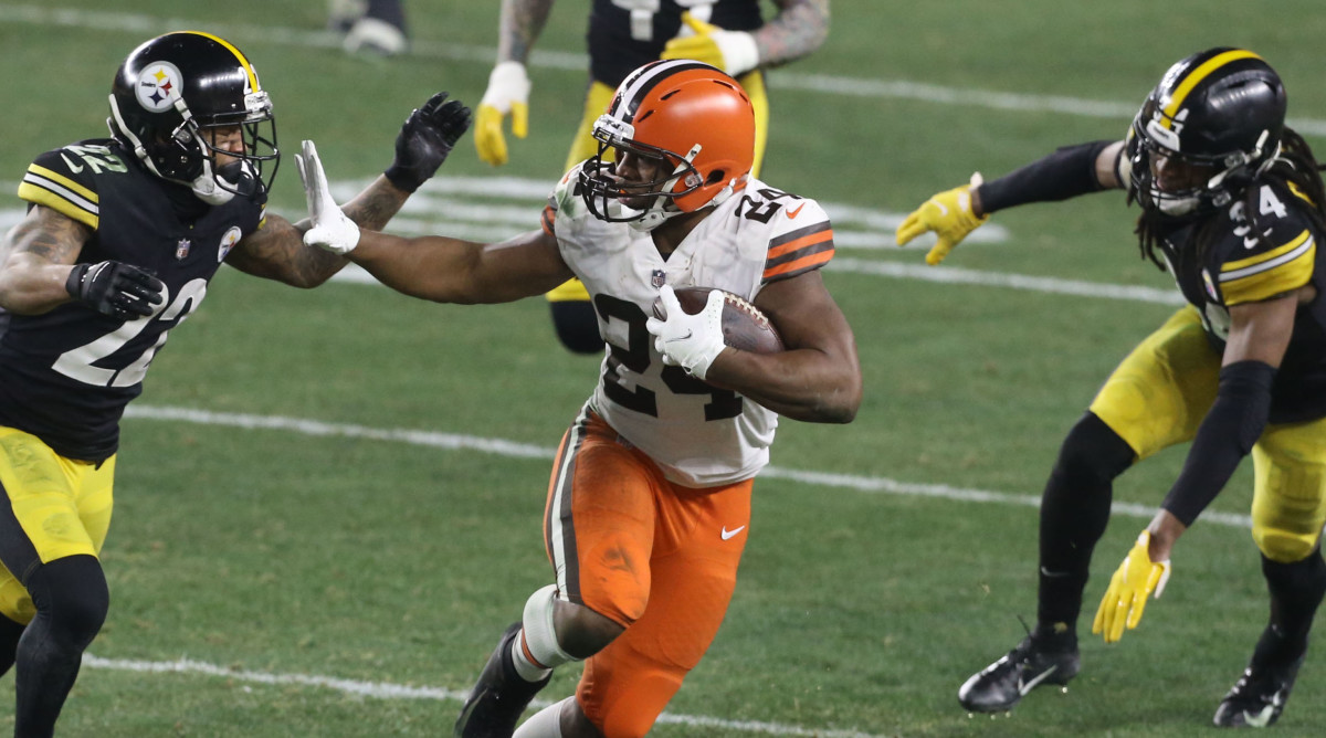 Cleveland Browns running back Nick Chubb (24) runs away from Pittsburgh Steelers cornerback Steven Nelson (22) in the second quarter of an AFC Wild Card playoff game at Heinz Field.