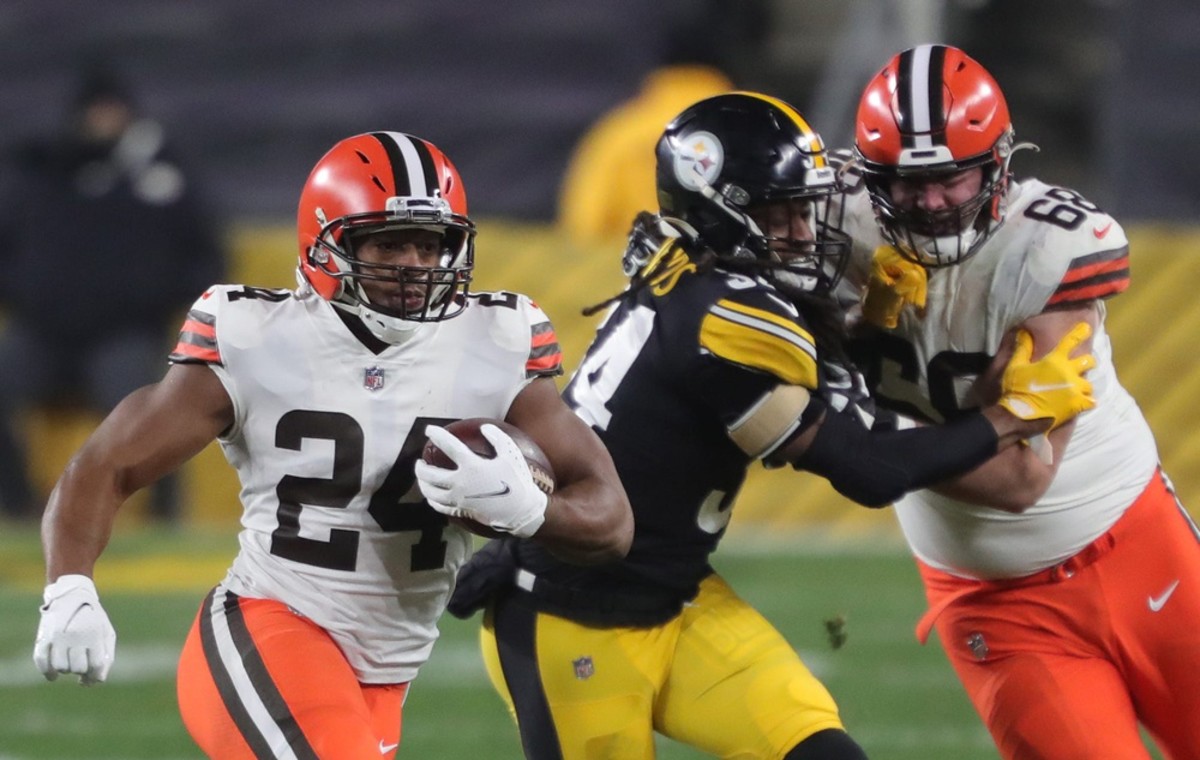 Cleveland Browns running back Nick Chubb (24) rushes to the sideline as Cleveland Browns offensive tackle Michael Dunn (68) blocks Pittsburgh Steelers strong safety Terrell Edmunds (34) during the first half of an NFL wild-card playoff football game, Sunday, Jan. 10, 2021, in Pittsburgh, Pennsylvania. [Jeff Lange/Beacon Journal] Browns Extras 17