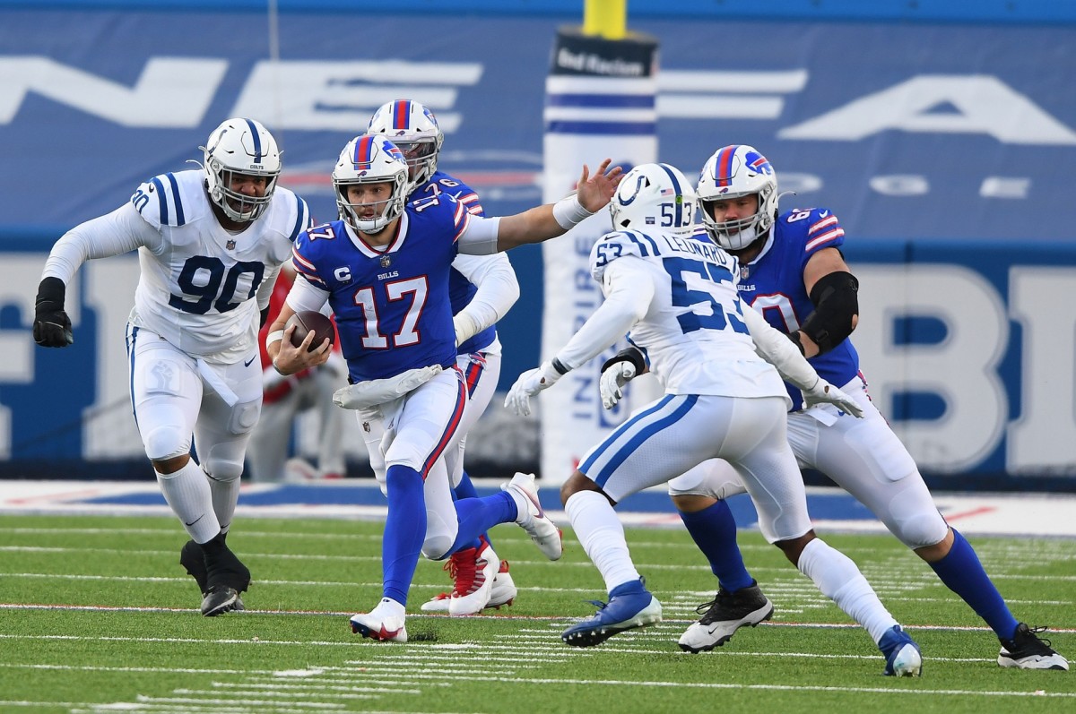 Bills quarterback Josh Allen (17) runs between Indianapolis Colts defensive tackle Grover Stewart (90) and outside linebacker Darius Leonard (53).