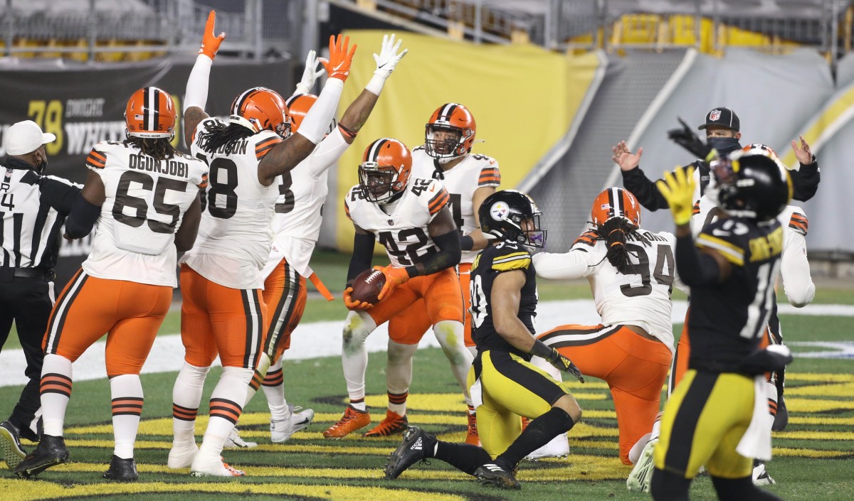 Cleveland Browns strong safety Karl Joseph (42) celebrates after recovering a fumble for a touchdown against the Pittsburgh Steelers in the first half of an AFC Wild Card playoff game at Heinz Field.