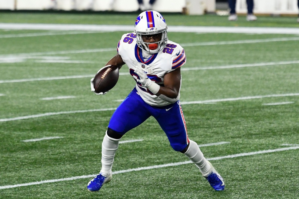 Dec 28, 2020; Foxborough, Massachusetts, USA; Buffalo Bills running back Devin Singletary (26) runs with the ball against the New England Patriots during the first quarter at Gillette Stadium.