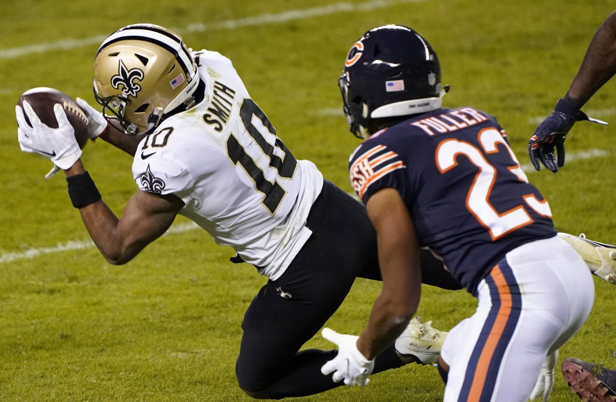 Nov 1, 2020; Chicago, Illinois, USA; New Orleans Saints wide receiver Tre'Quan Smith (10) makes a catch against the Chicago Bears cornerback Kyle Fuller (23) during the fourth quarter at Soldier Field. Mandatory Credit: Mike Dinovo-USA TODAY Sports