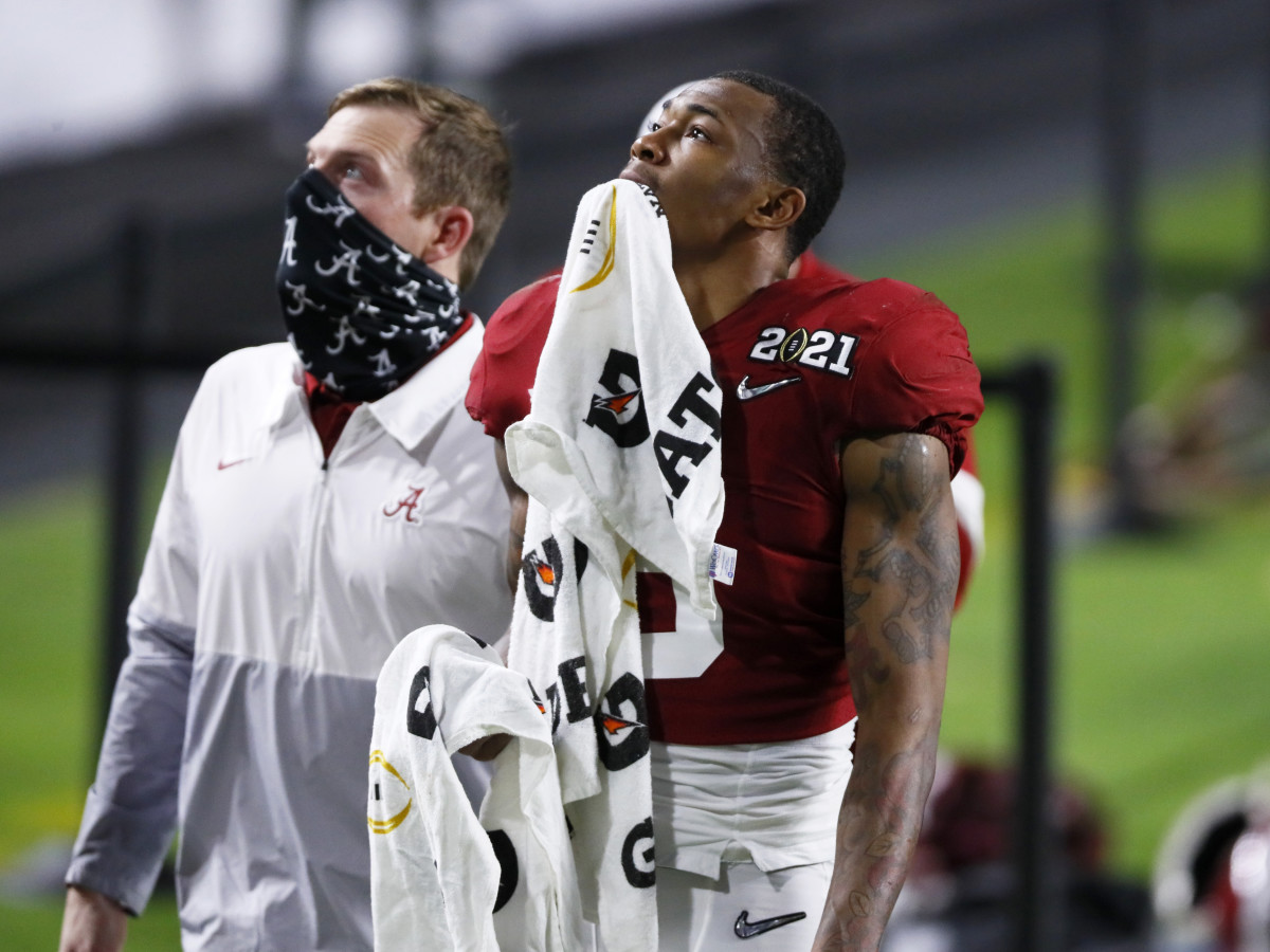 Jan. 11, 2021; Miami Gardens, Florida, USA; After a lengthy stay in the medical tent with trainers, Alabama Crimson Tide wide receiver DeVonta Smith (6) exits the field with a towel on his injured hand during the third quarter of the College Football Playoff National Championship against the Ohio State Buckeyes at Hard Rock Stadium in Miami Gardens, Fla.