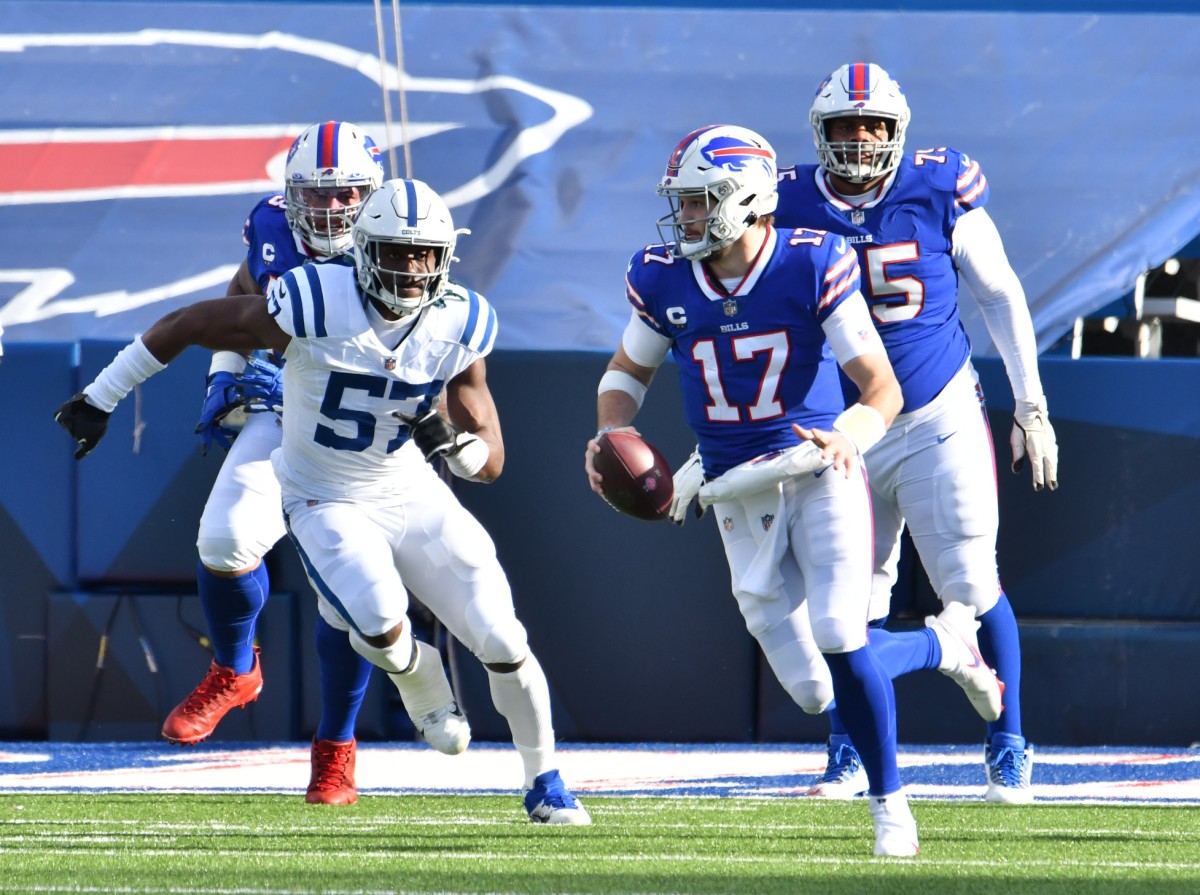 Bills quarterback Josh Allen (17) runs from Indianapolis Colts defensive end Kemoko Turay (57) in divisional round playoff game.