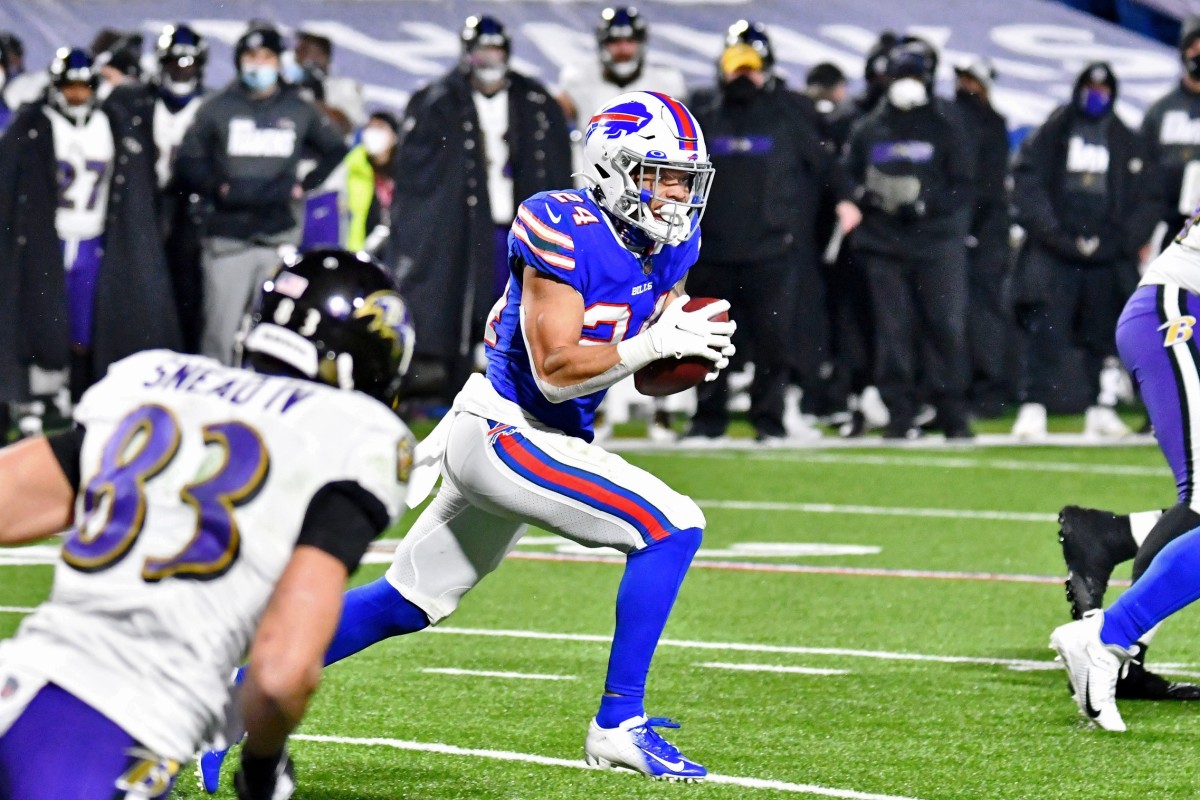 Bills cornerback Taron Johnson (24) runs with the ball for a touchdown after making an interception against the Baltimore Ravens.