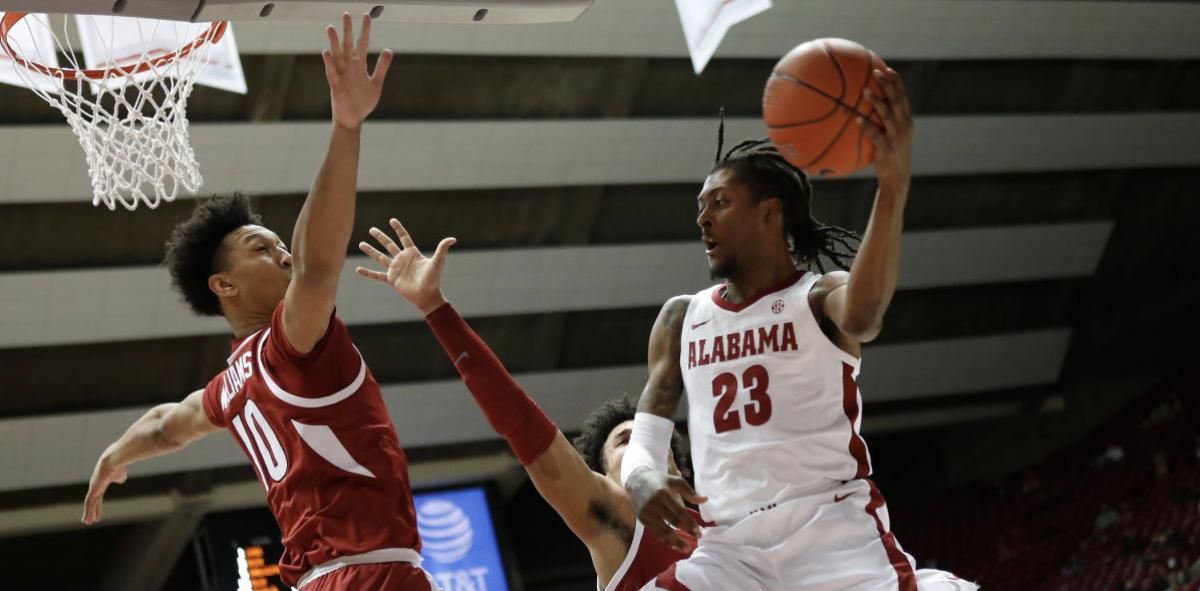 January 16, 2021, Alabama basketball guard John Petty Jr. looks for a teammate against Arkansas in Tuscaloosa, AL.