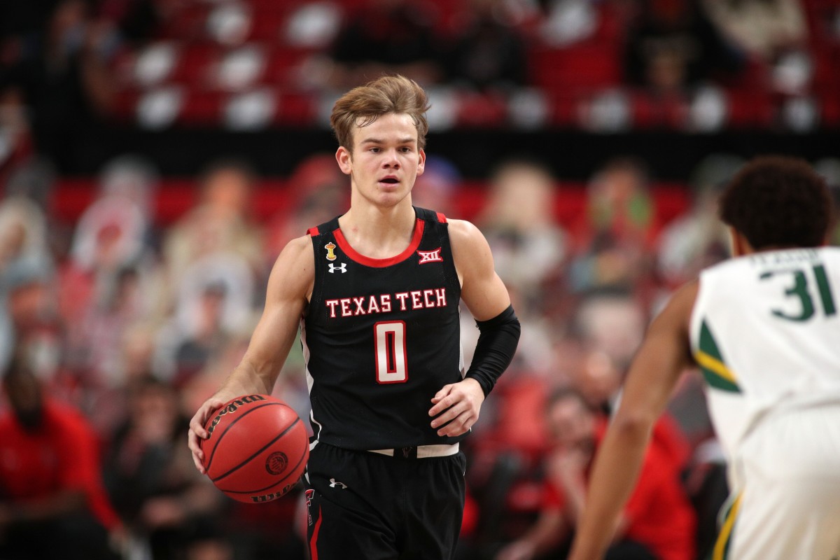 Jan 16, 2021; Lubbock, Texas, USA; Texas Tech Red Raiders guard Mac McClung (0) brings the ball up court against Baylor Bears guard MaCio Teague (31) in the first half at United Supermarkets Arena.
