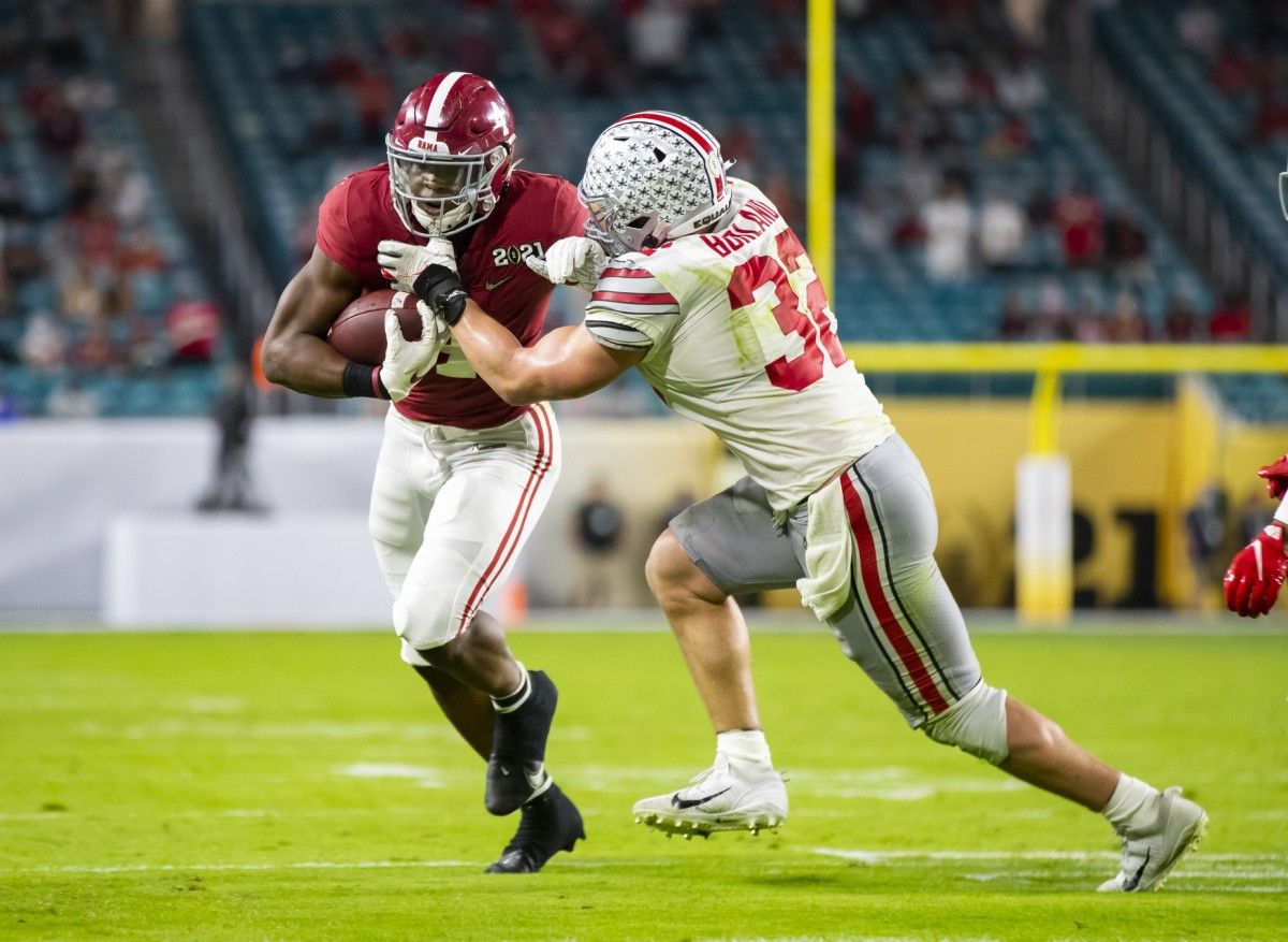Alabama Crimson Tide running back Brian Robinson Jr. (4) against Ohio State Buckeyes linebacker Tuf Borland (32) in the 2021 College Football Playoff National Championship Game.