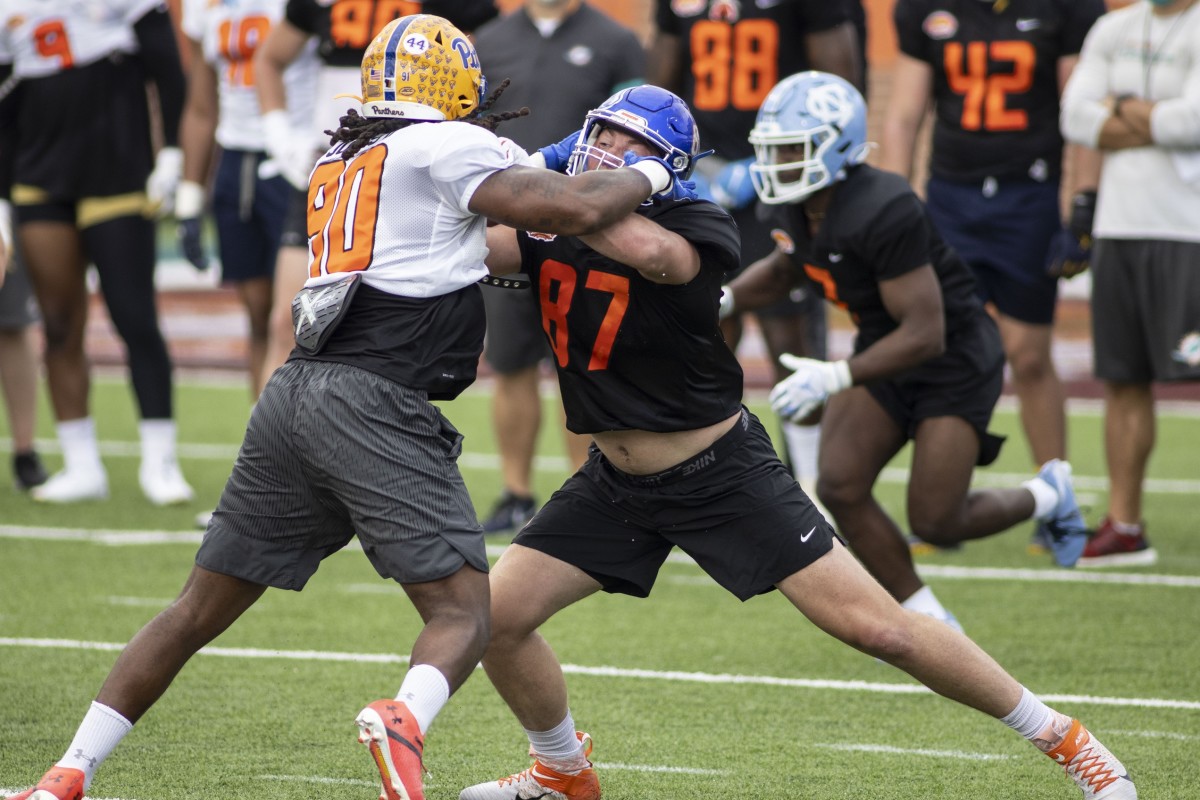 National defensive lineman Patrick Jones II of Pittsburgh (90) drills with National tight end John Bates of Boise State (87) during National team practice during the 2021 Senior Bowl week.