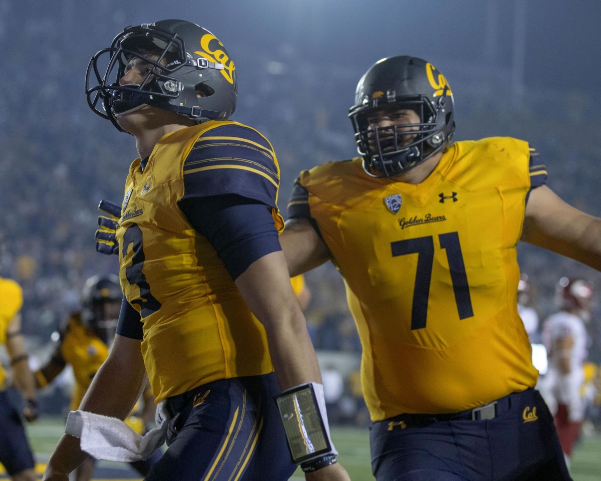 California Golden Bears quarterback Ross Bowers (3) celebrates with California Golden Bears offensive lineman Jake Curhan (71) after leaping for a touchdown against the Washington State Cougars during the second half at Memorial Stadium.